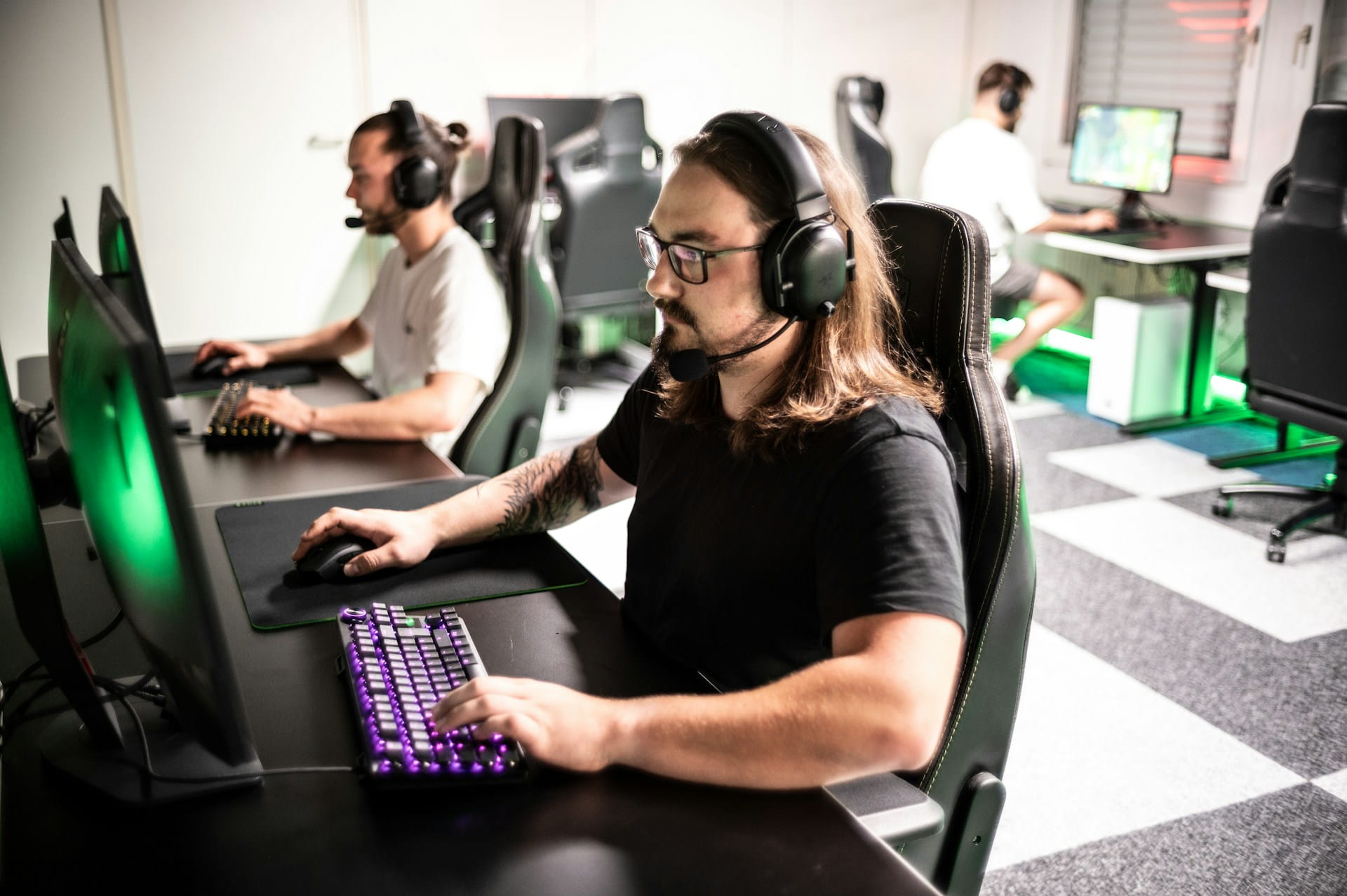 Photo of multiple people playing a PC video game